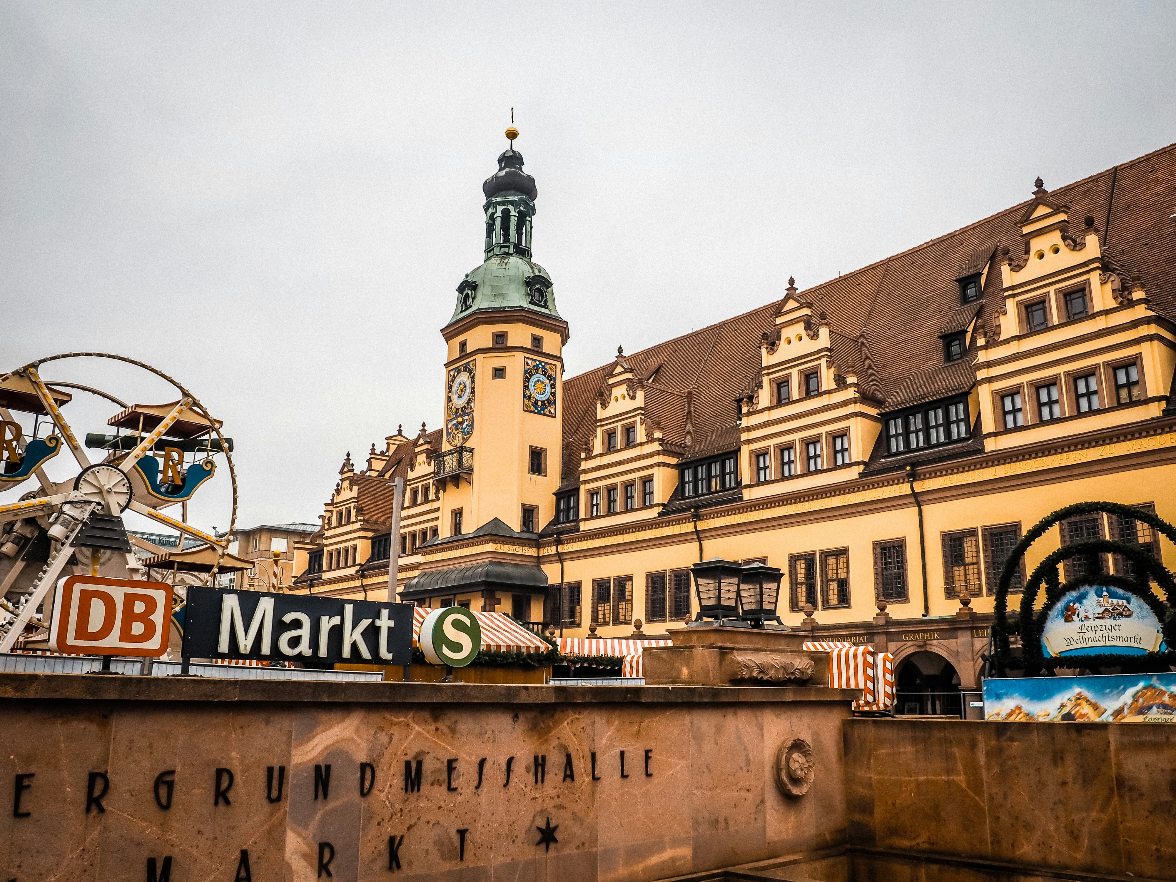 Historic buildings and market near a train station.