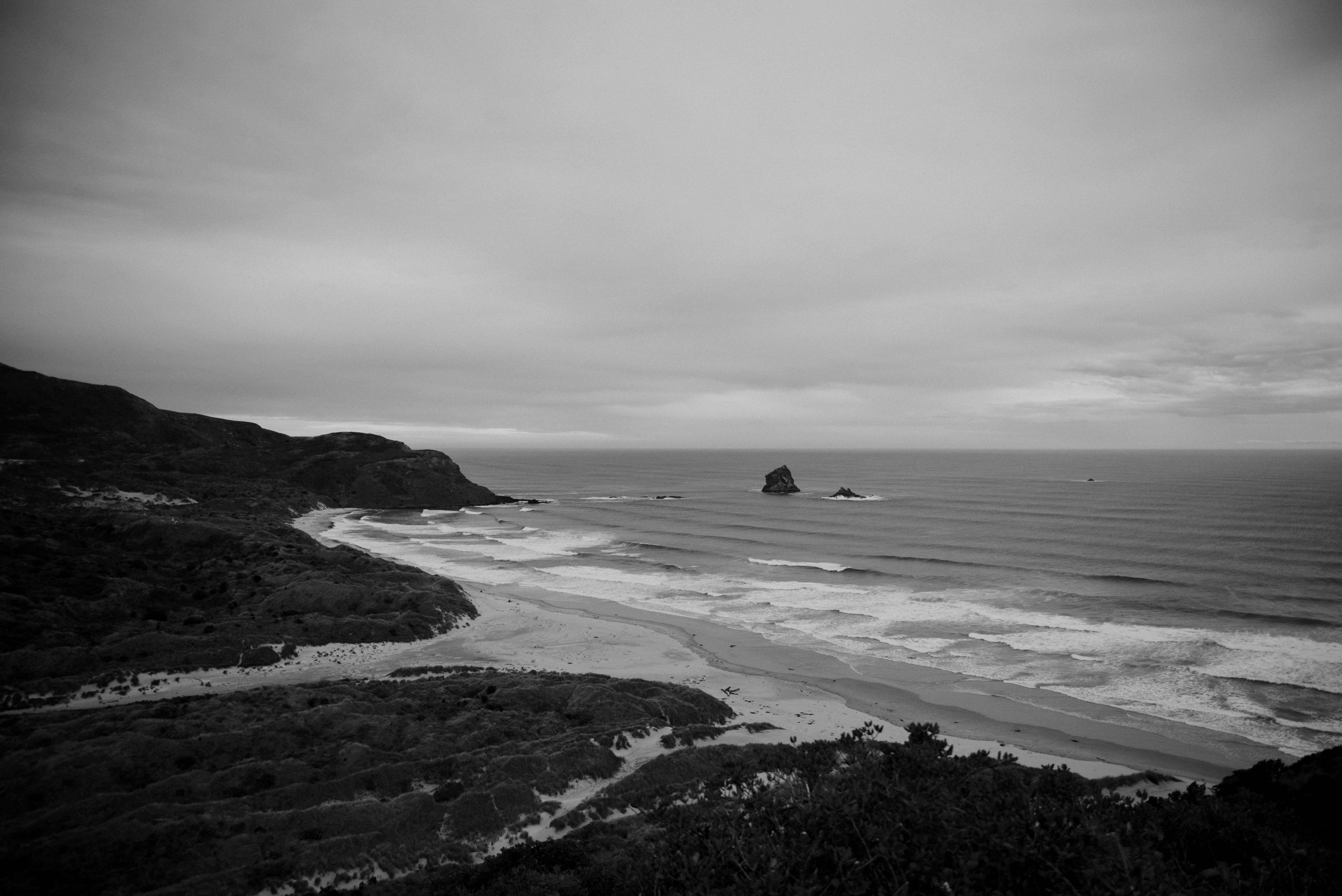 A moody beachscape under a cloudy sky.