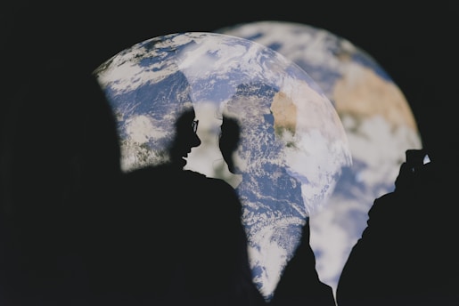 Silhouette of person observing images of earth.