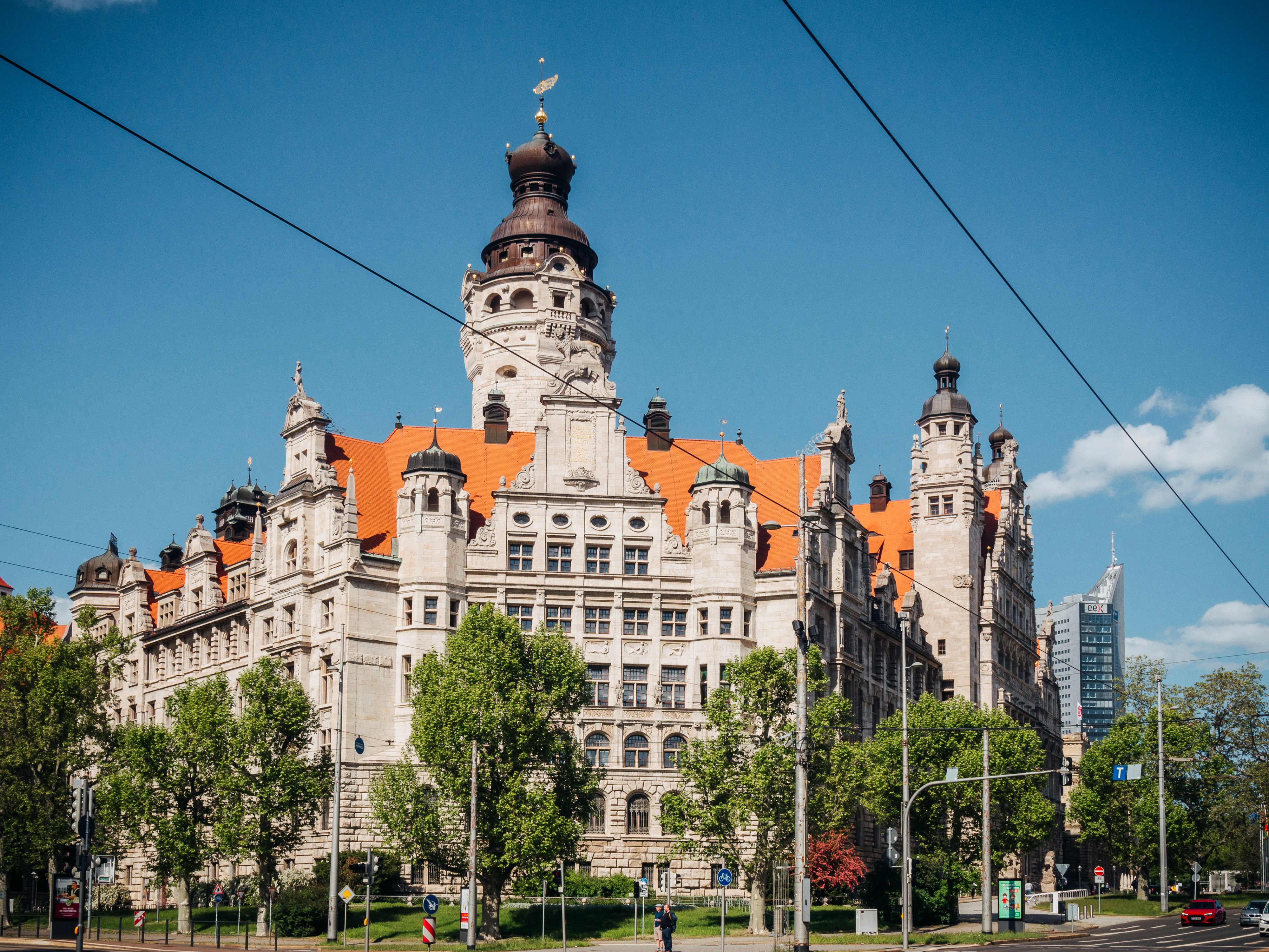A large ornate building stands under a bright blue sky.