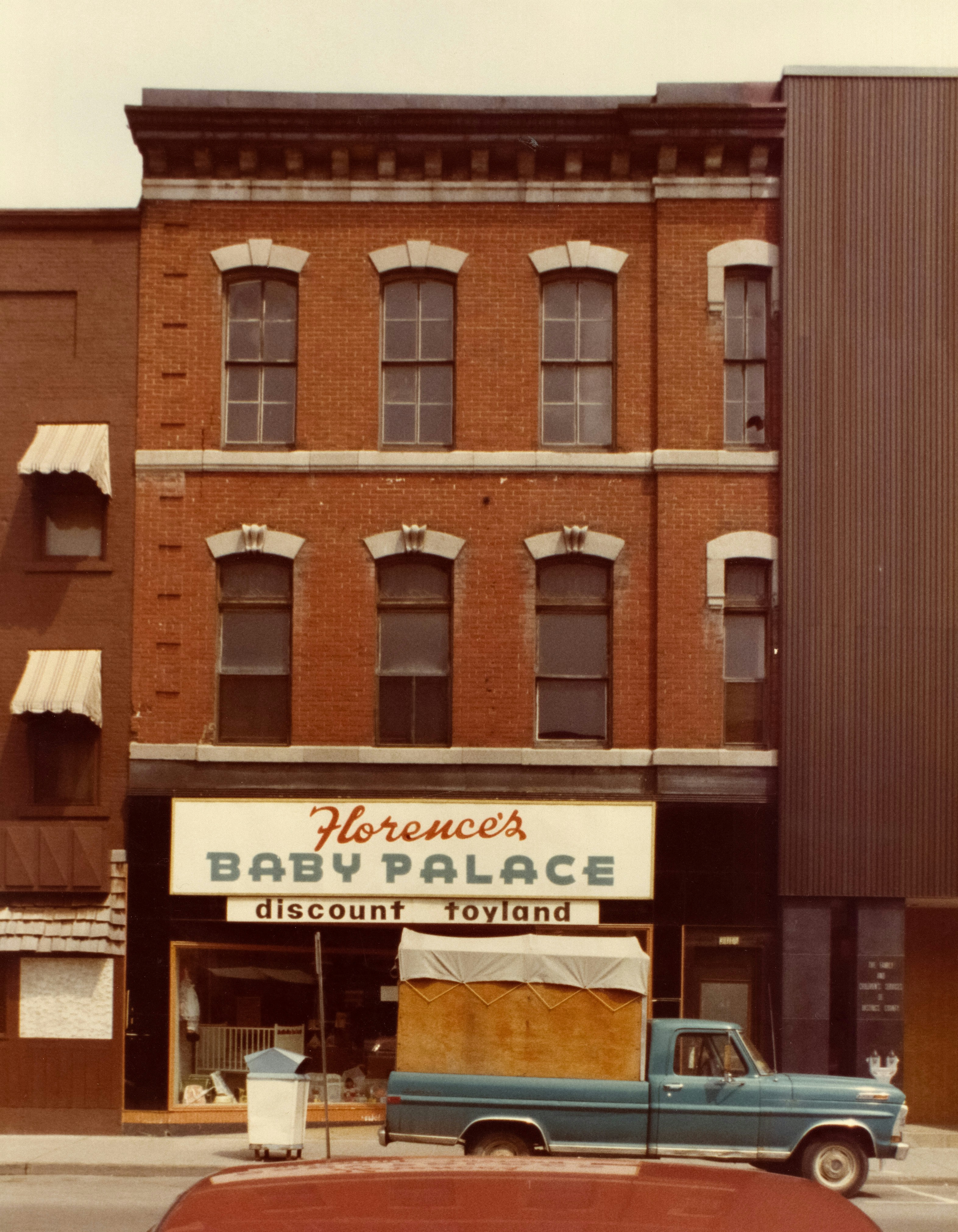 Florence's baby palace storefront with delivery truck photo – Free City ...