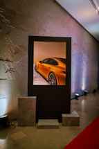 A car displayed within a frame on the wall.