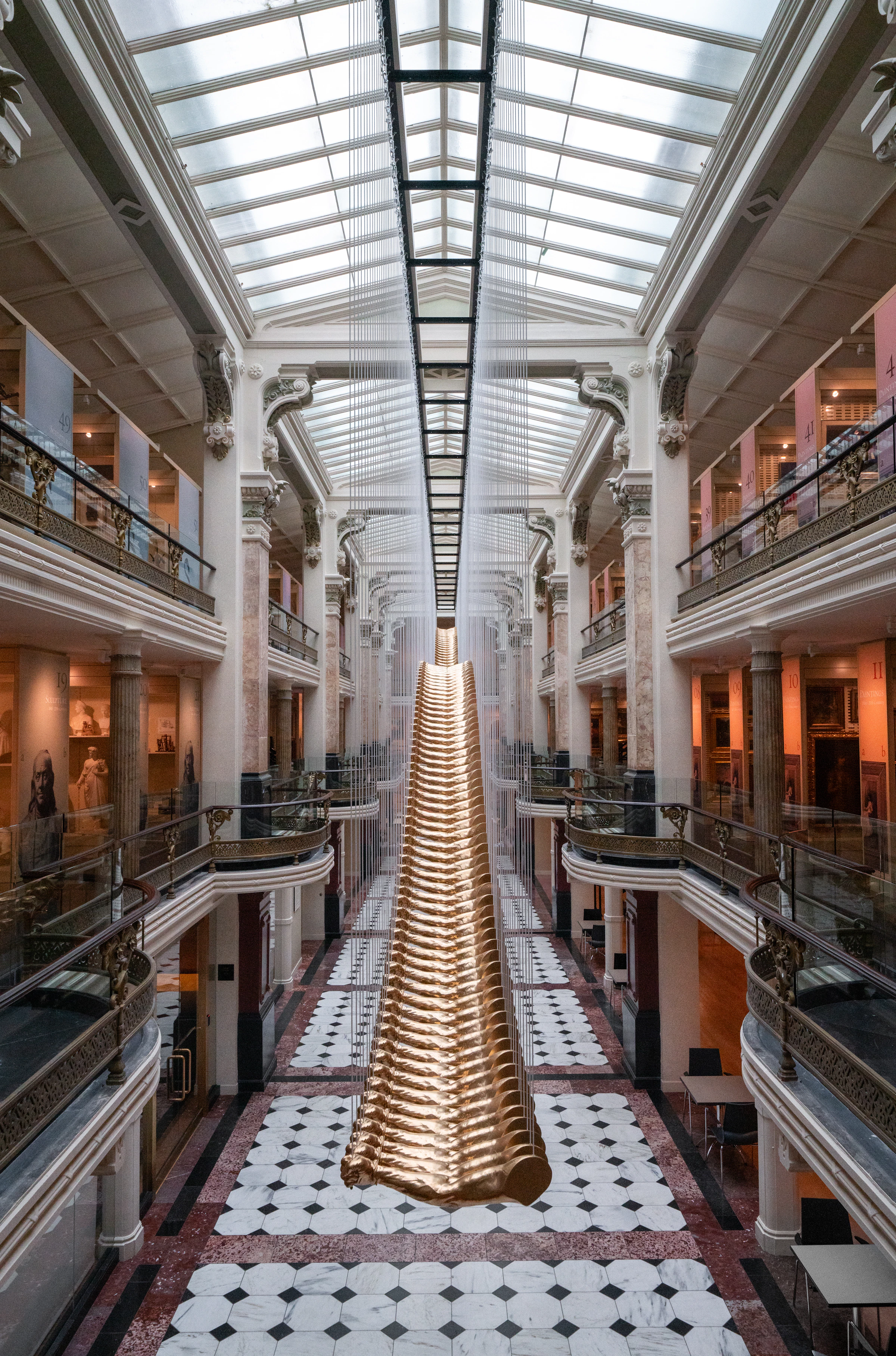 Large-scale art installation suspended in a museum atrium