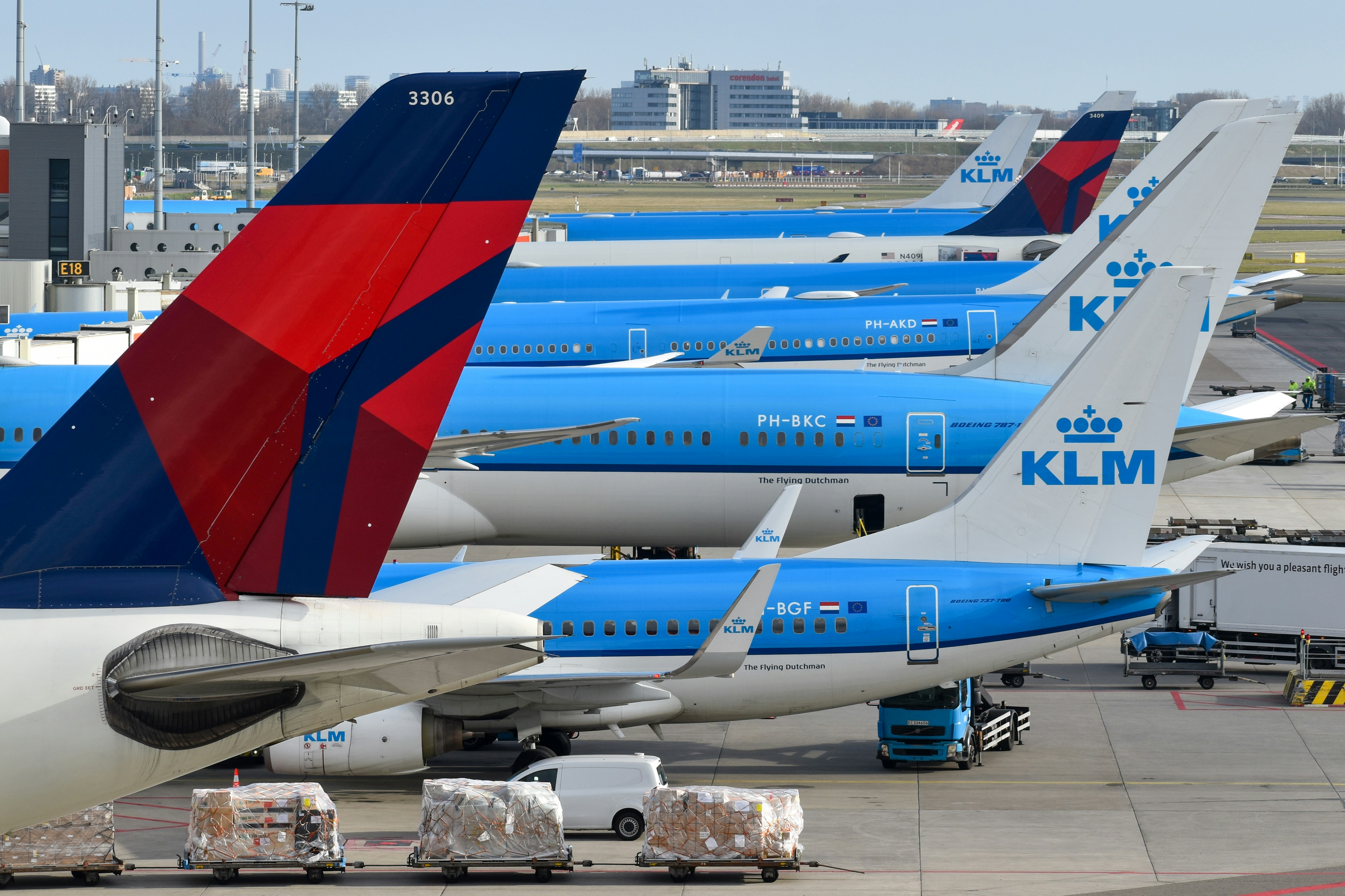 Airplanes from klm and delta at an airport., Delta Air Lines and KLM jets at Amsterdam Schipol
