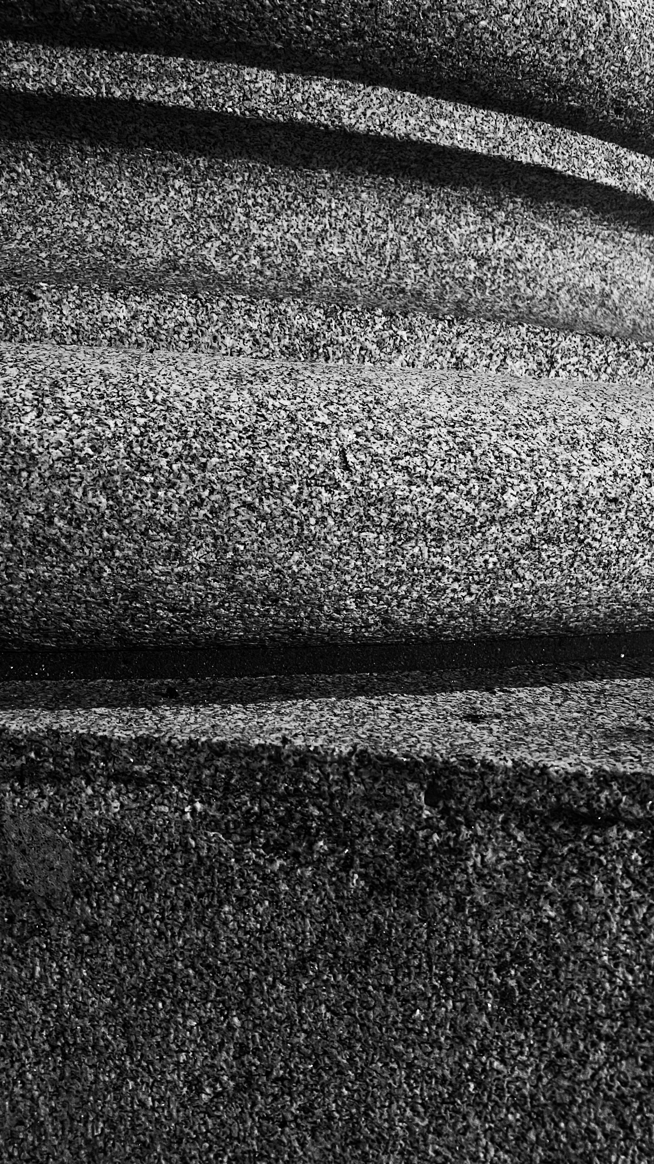 Textured gray surface with curved grooves.