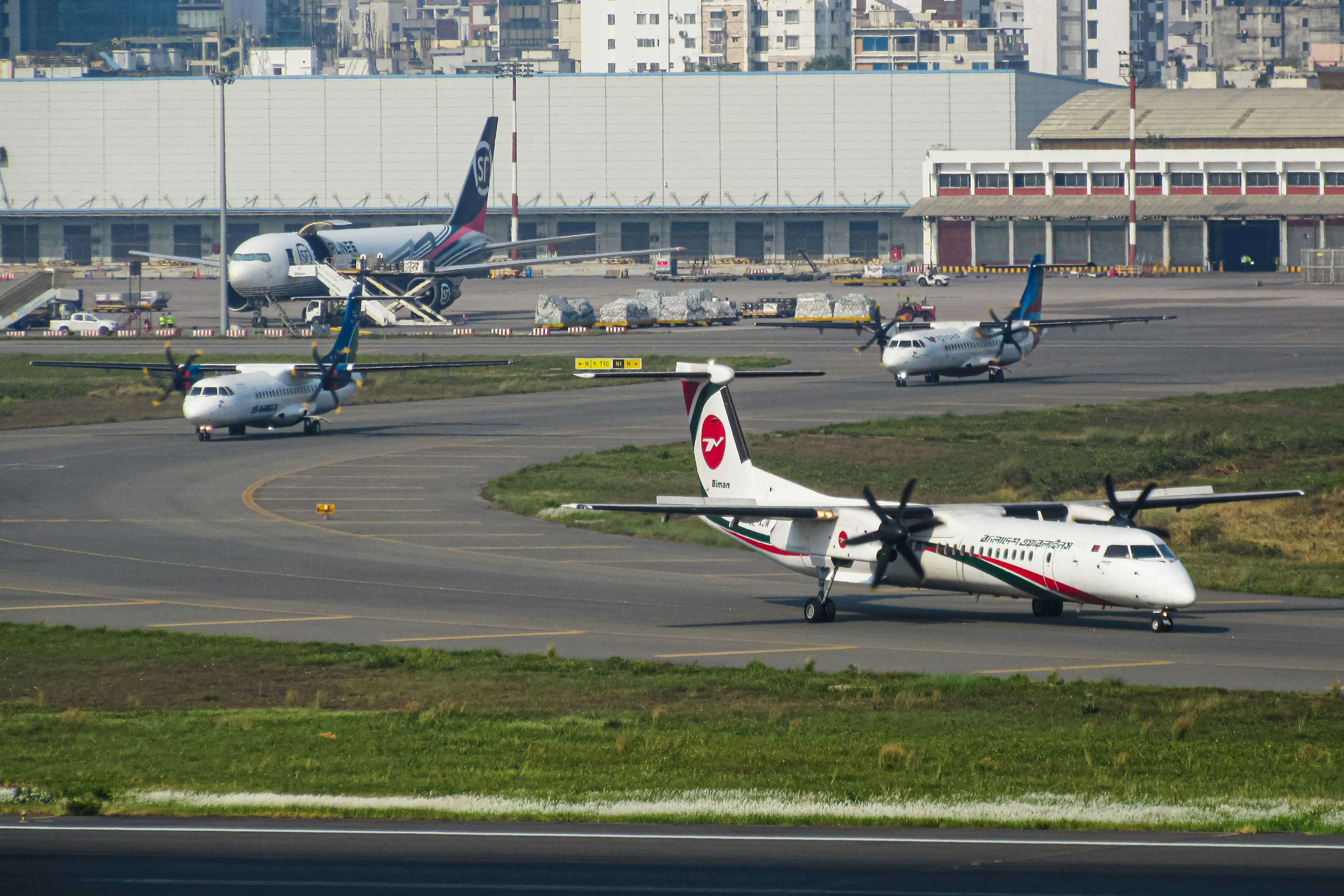 Airplanes are on the tarmac, ready to take off., Deshi Turboprops