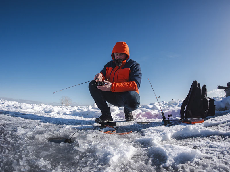 ice fisherman setting up on a frozen lake