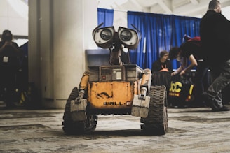 Wall-e robot is center in a convention hall.