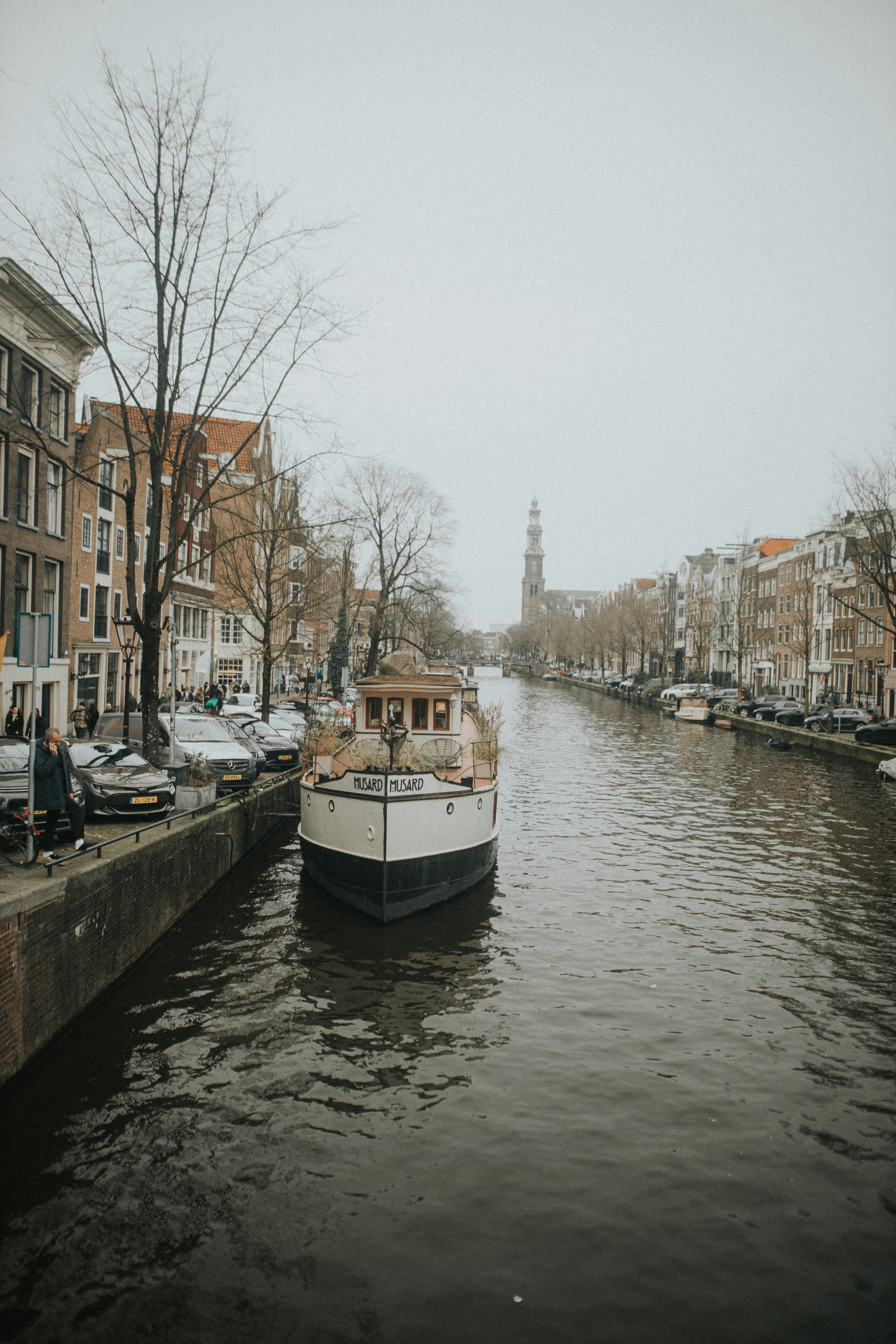 A boat cruises through an amsterdam canal.