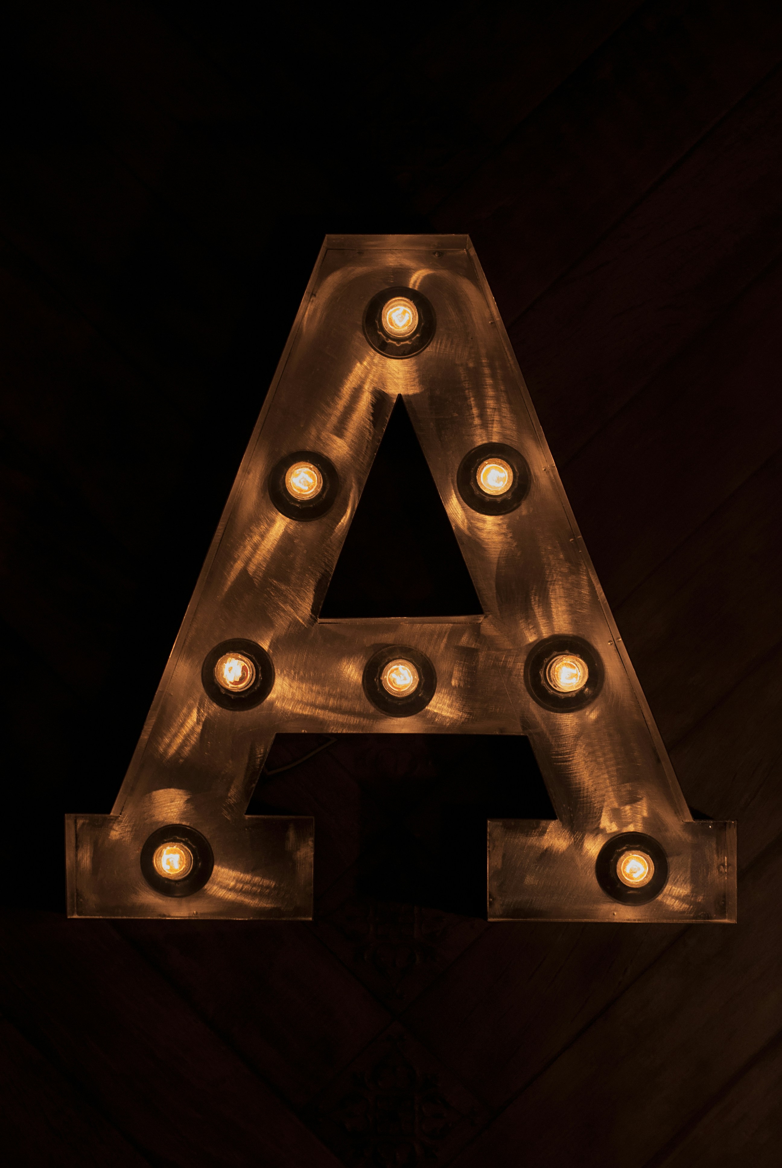 A lighted letter "a" is the focal point.