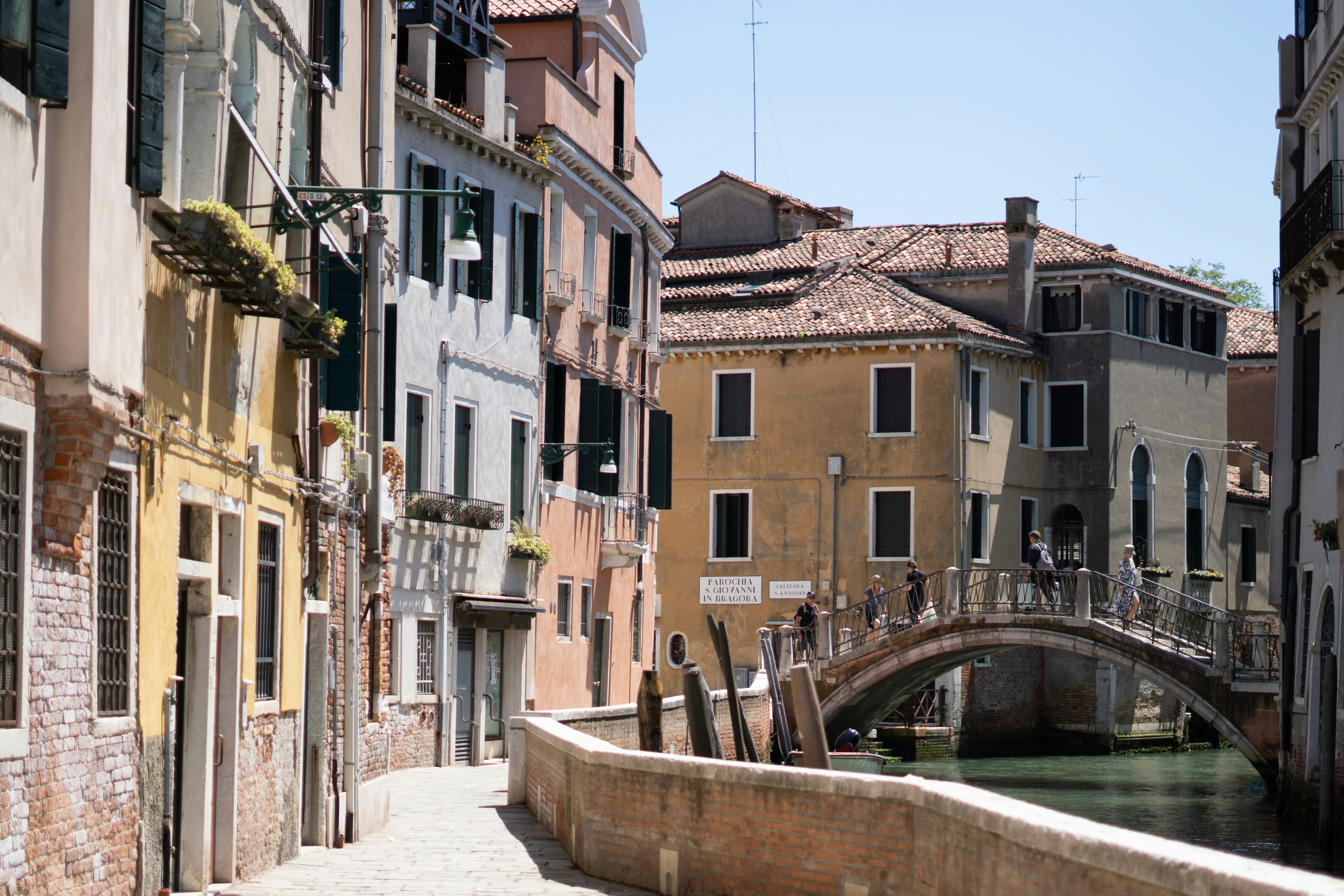 Venice canal and buildings under sunny skies.