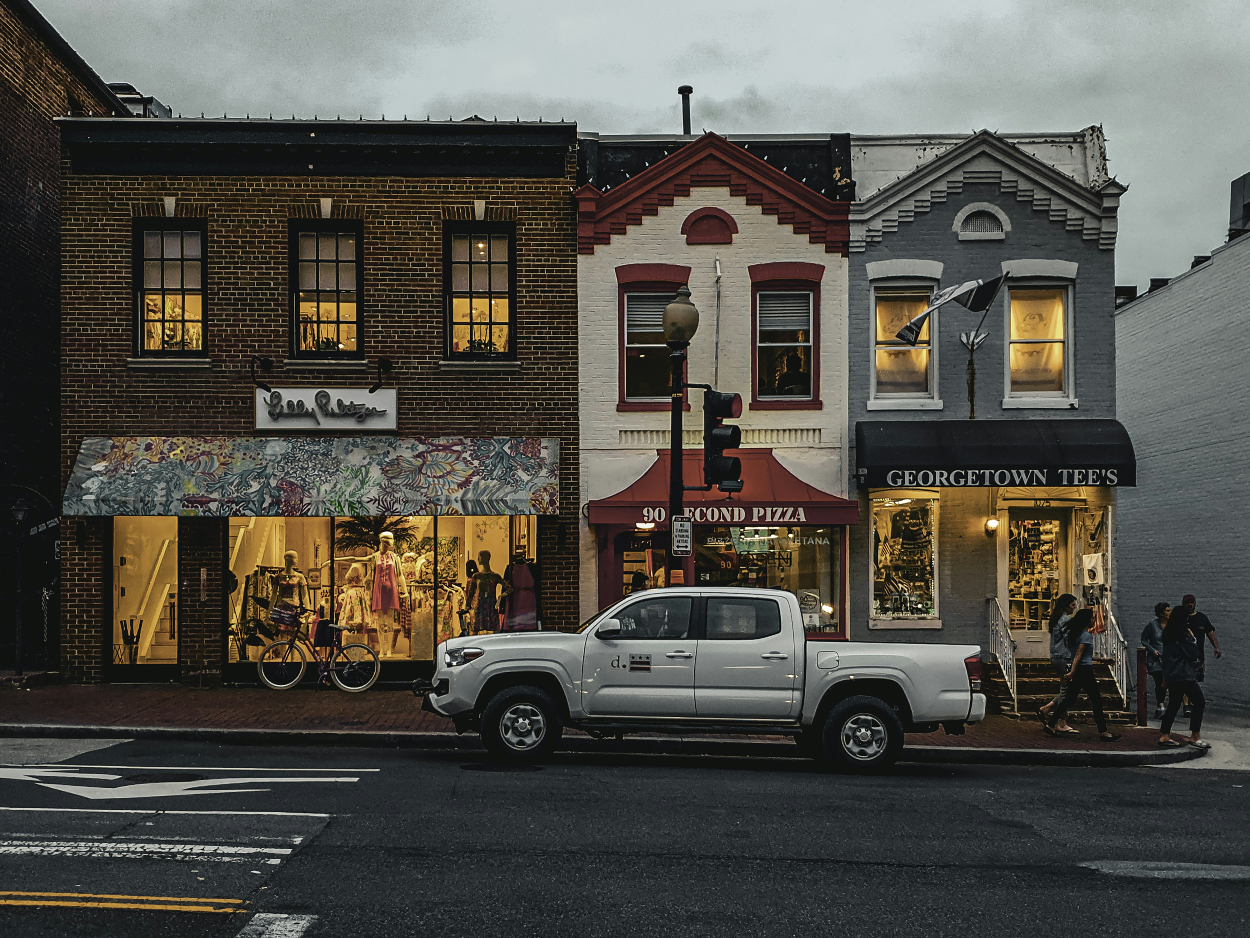 A busy local main street with various small business storefronts, illustrating the importance of local presence - local seo service company