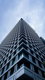 A modern skyscraper reaches up to the sky.
