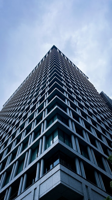A modern skyscraper reaches up to the sky.