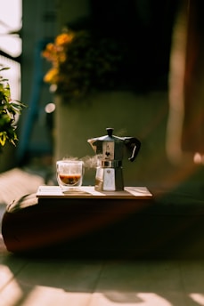 Coffee and a moka pot on a sunny day.
