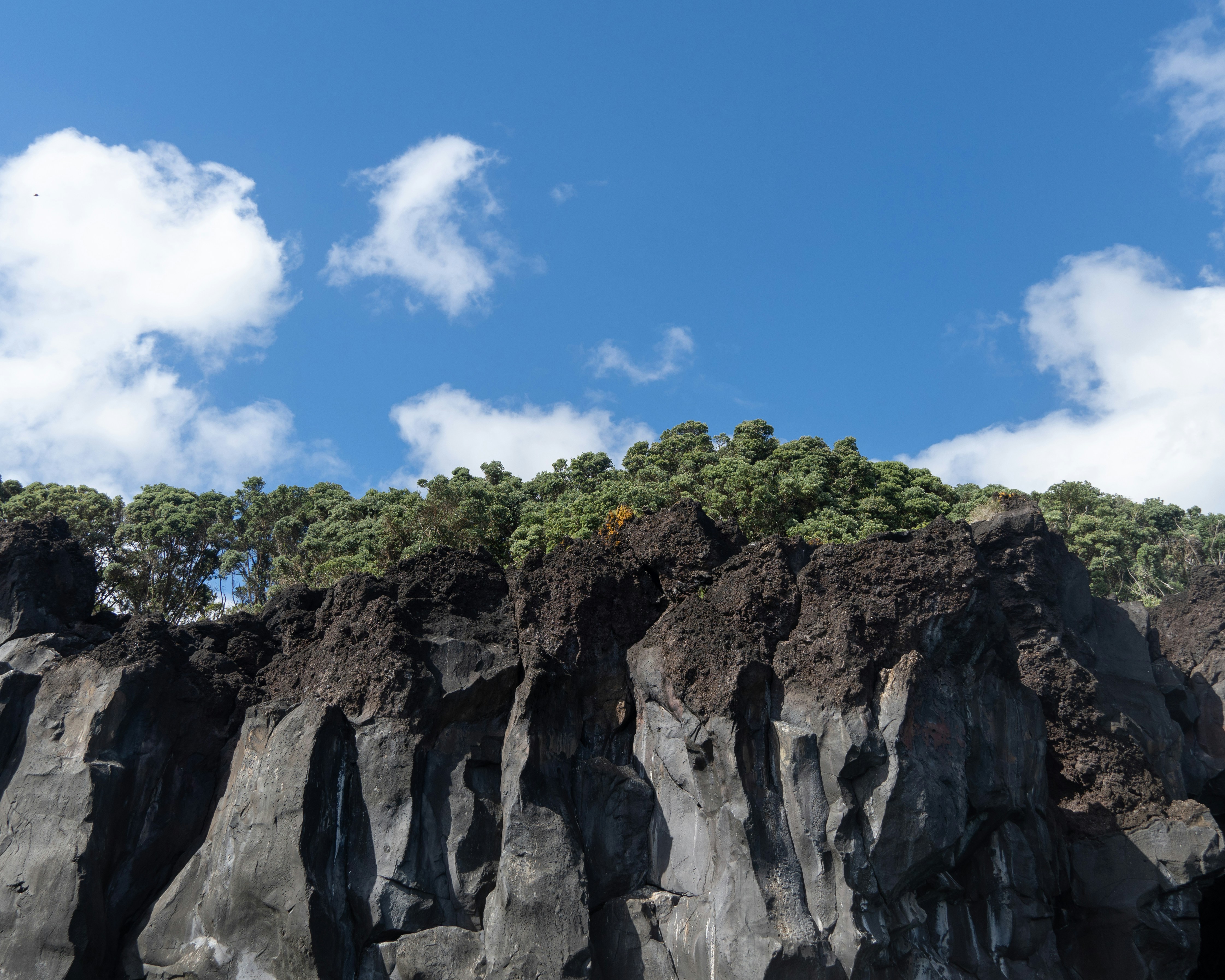 Rocky cliffs meet a beautiful sky.