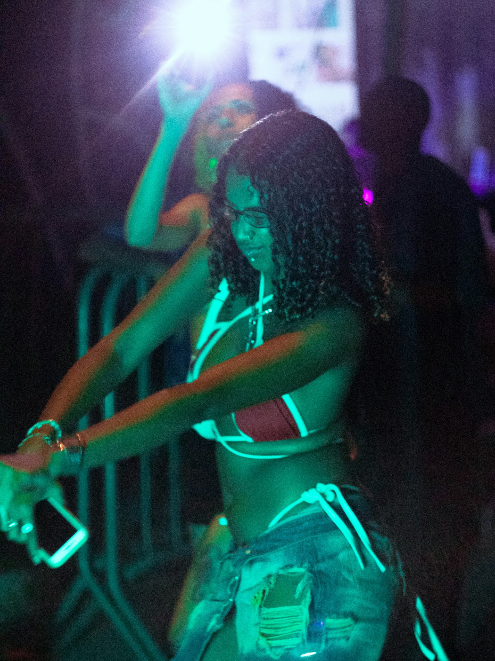 A woman dances with light and music.