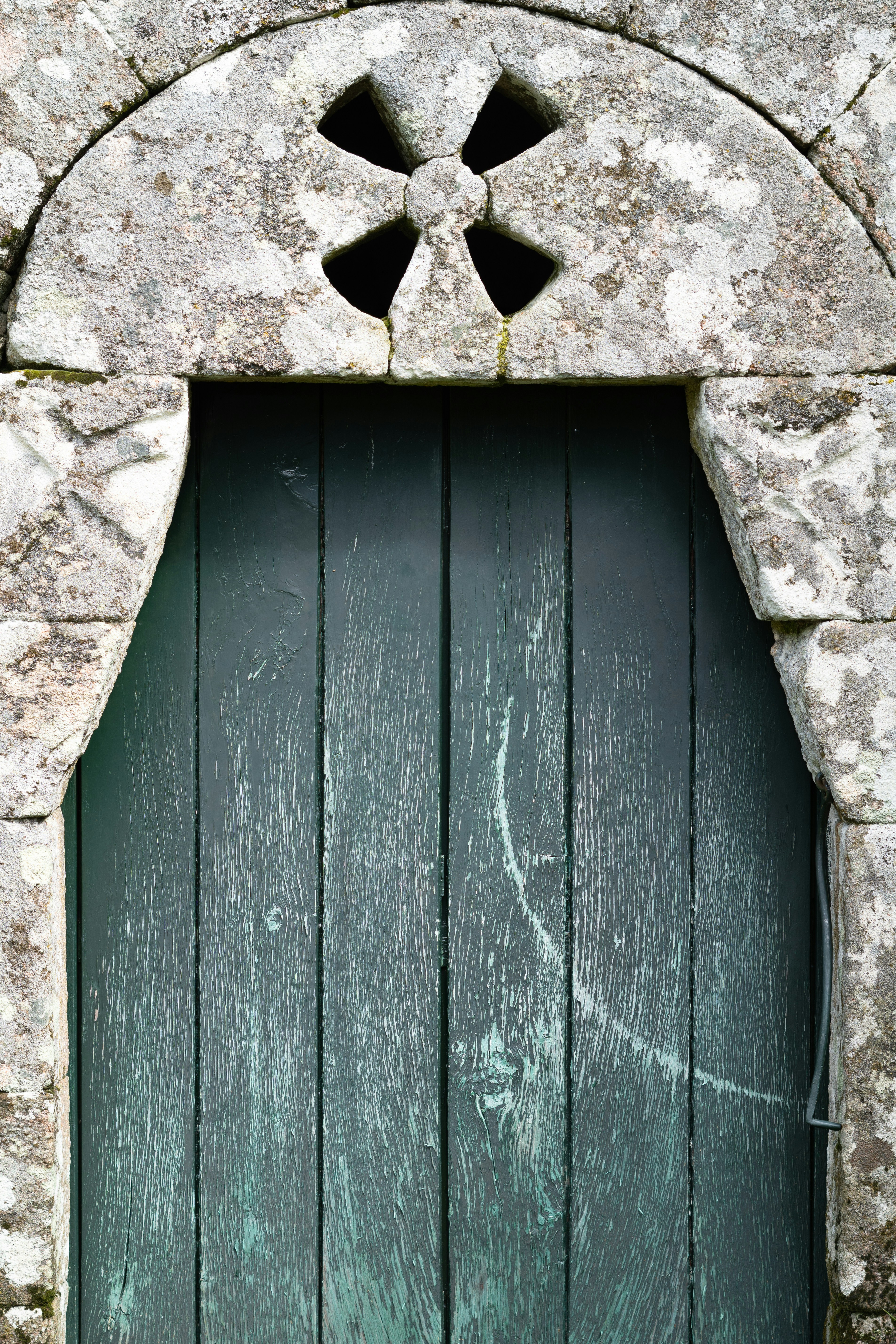 An old wooden door with stone detailing.