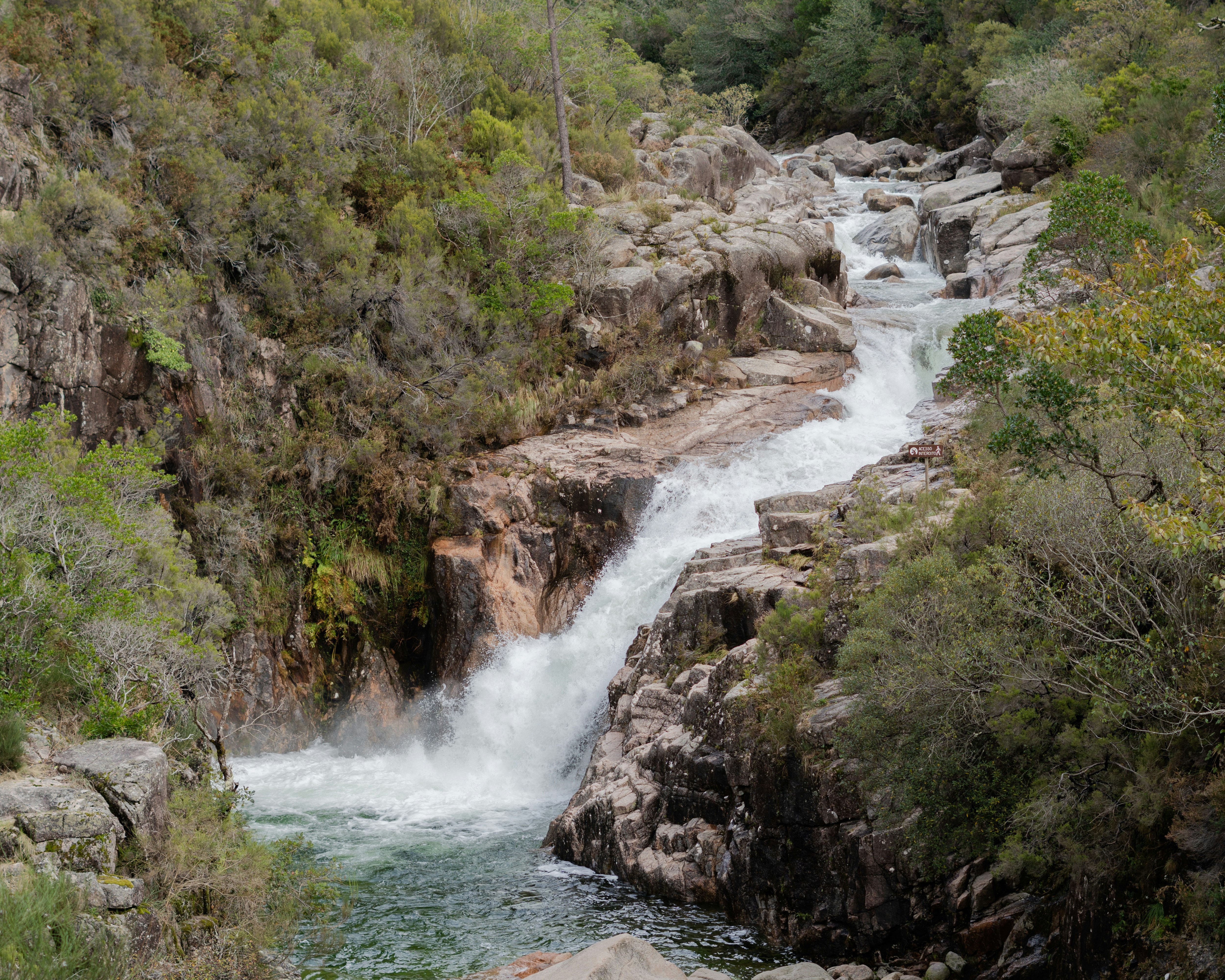 A waterfall cascades down a rocky mountainside.