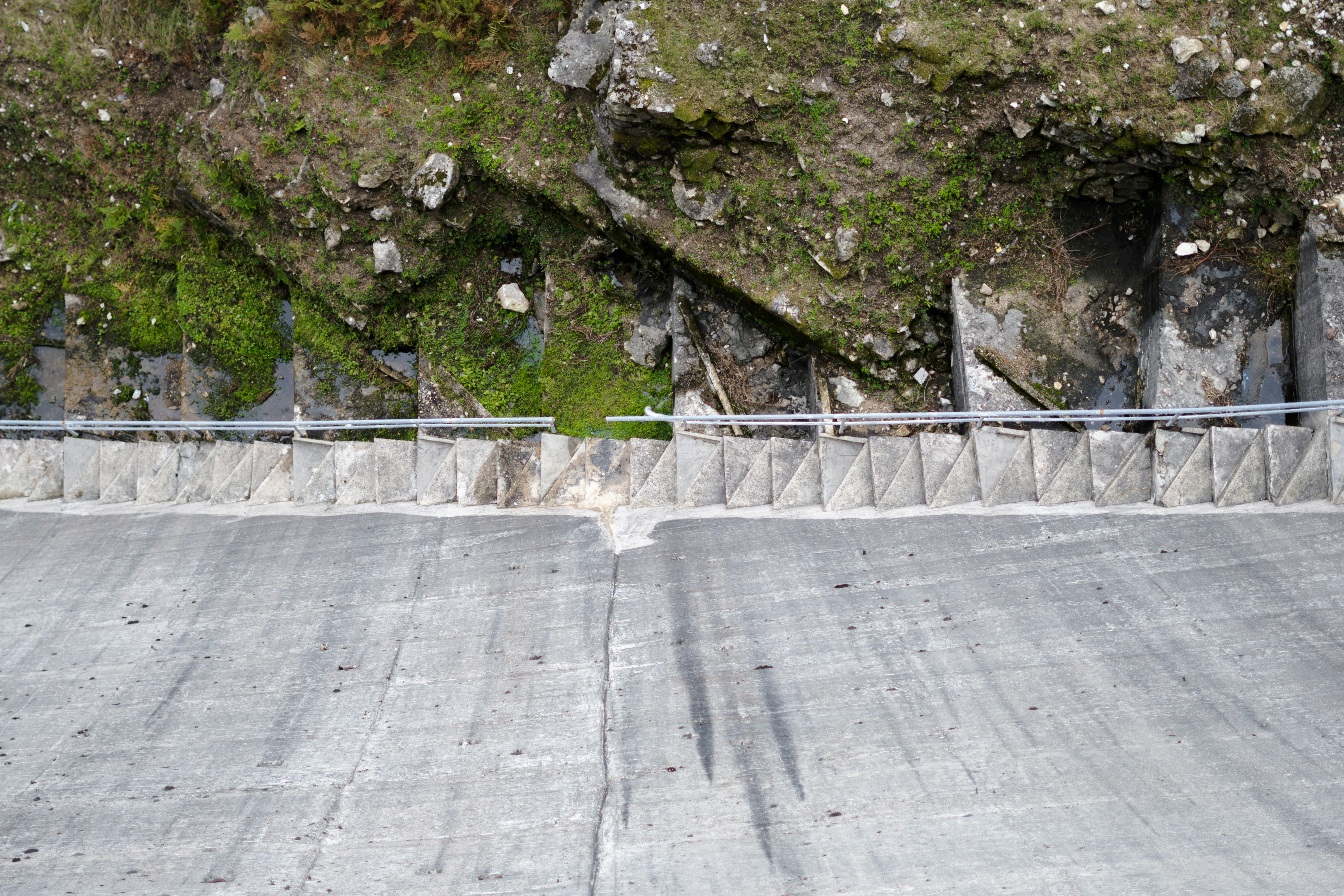 Dam wall and mountain side.