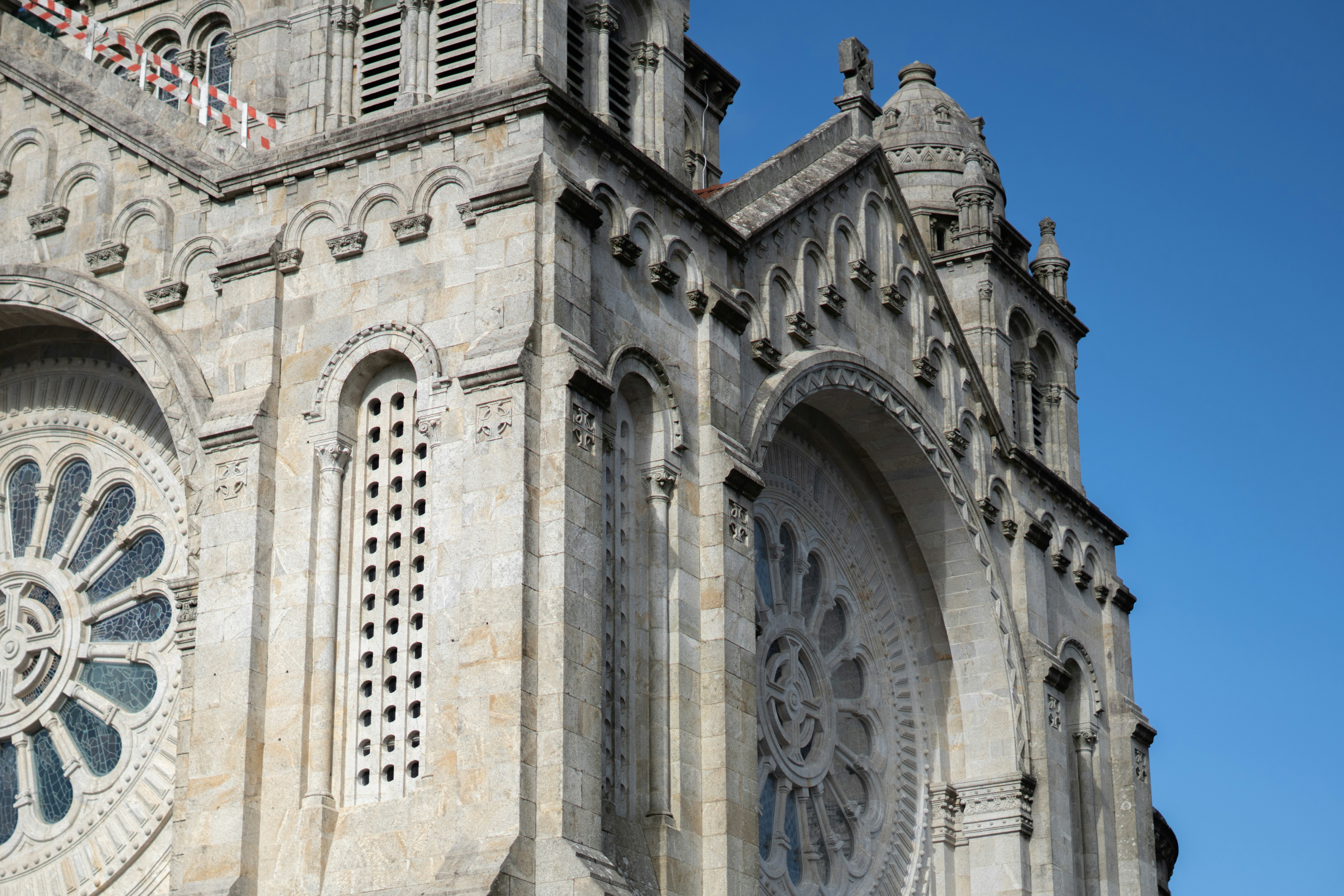 Stone building with intricate windows and decorations.
