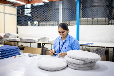 Woman sorts items at a factory workstation.