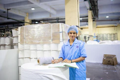 Woman working in a paper factory warehouse