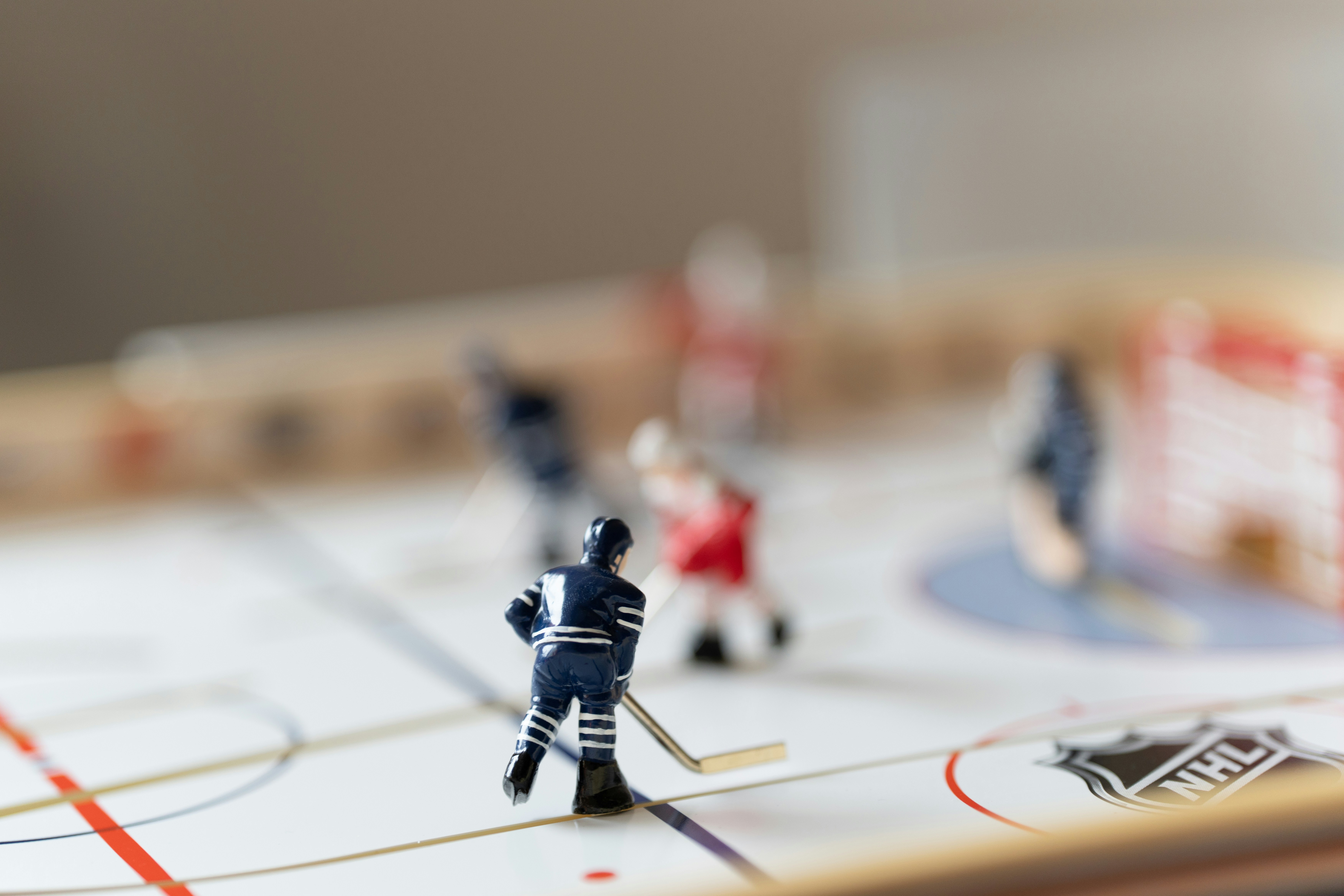 Miniature hockey game in action, with players.
