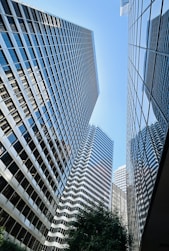 Skyscrapers reach high into a bright blue sky.