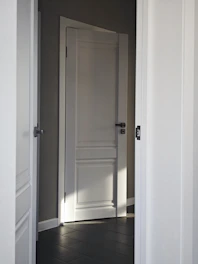 An open door reveals a room.