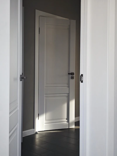 An open door reveals a room.