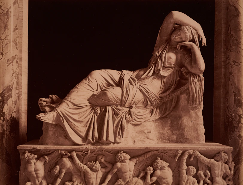 A sculpture of a reclining woman is shown.