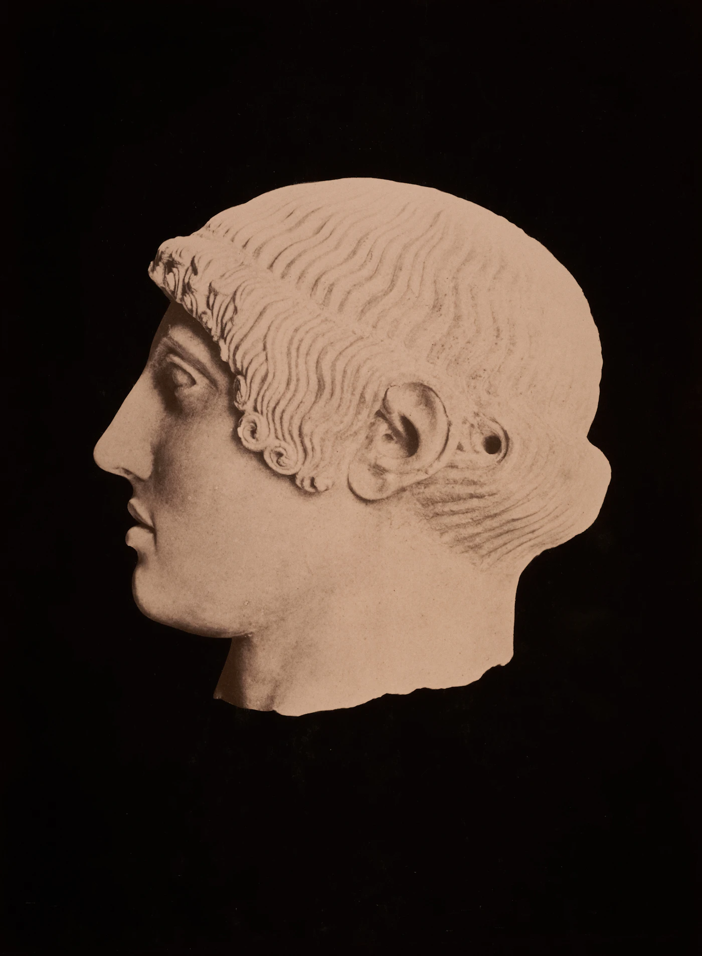 A Roman bust in profile against a dark backdrop