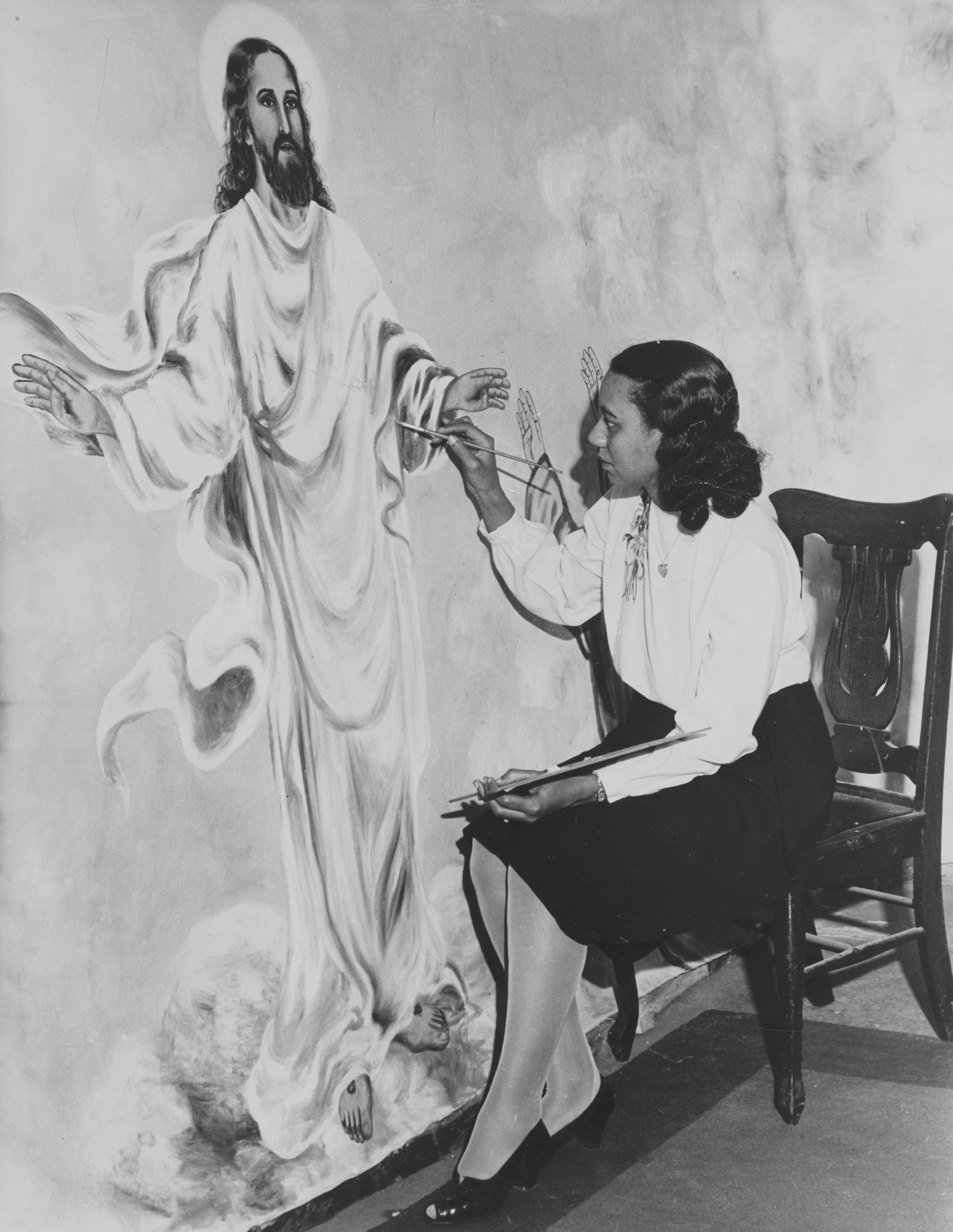 アーティストはイエスの壁画を描きます。