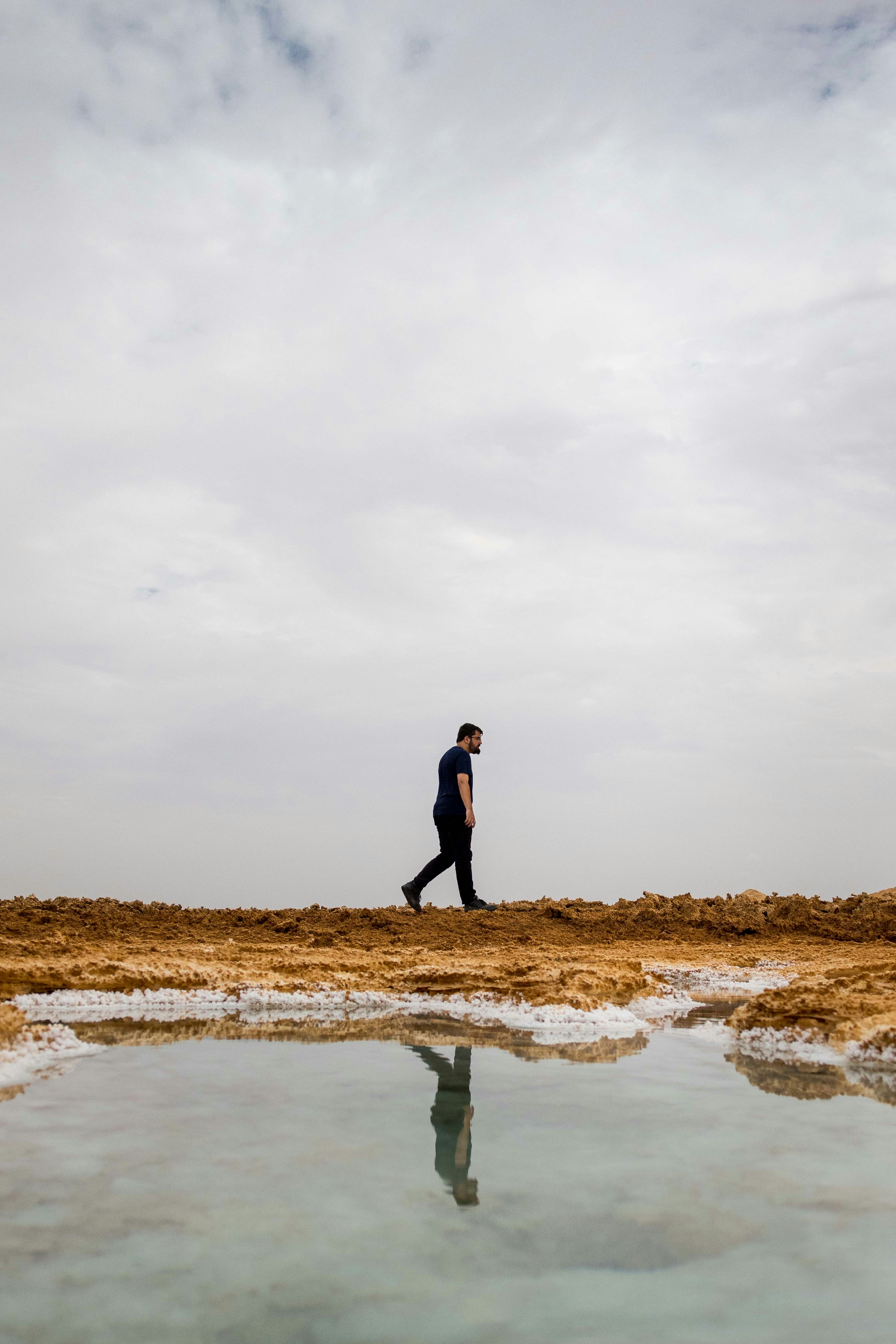 Man walking near a body of water.