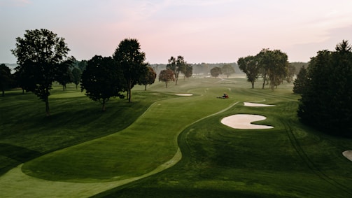 SAGG image of a golf course is surrounded by trees.