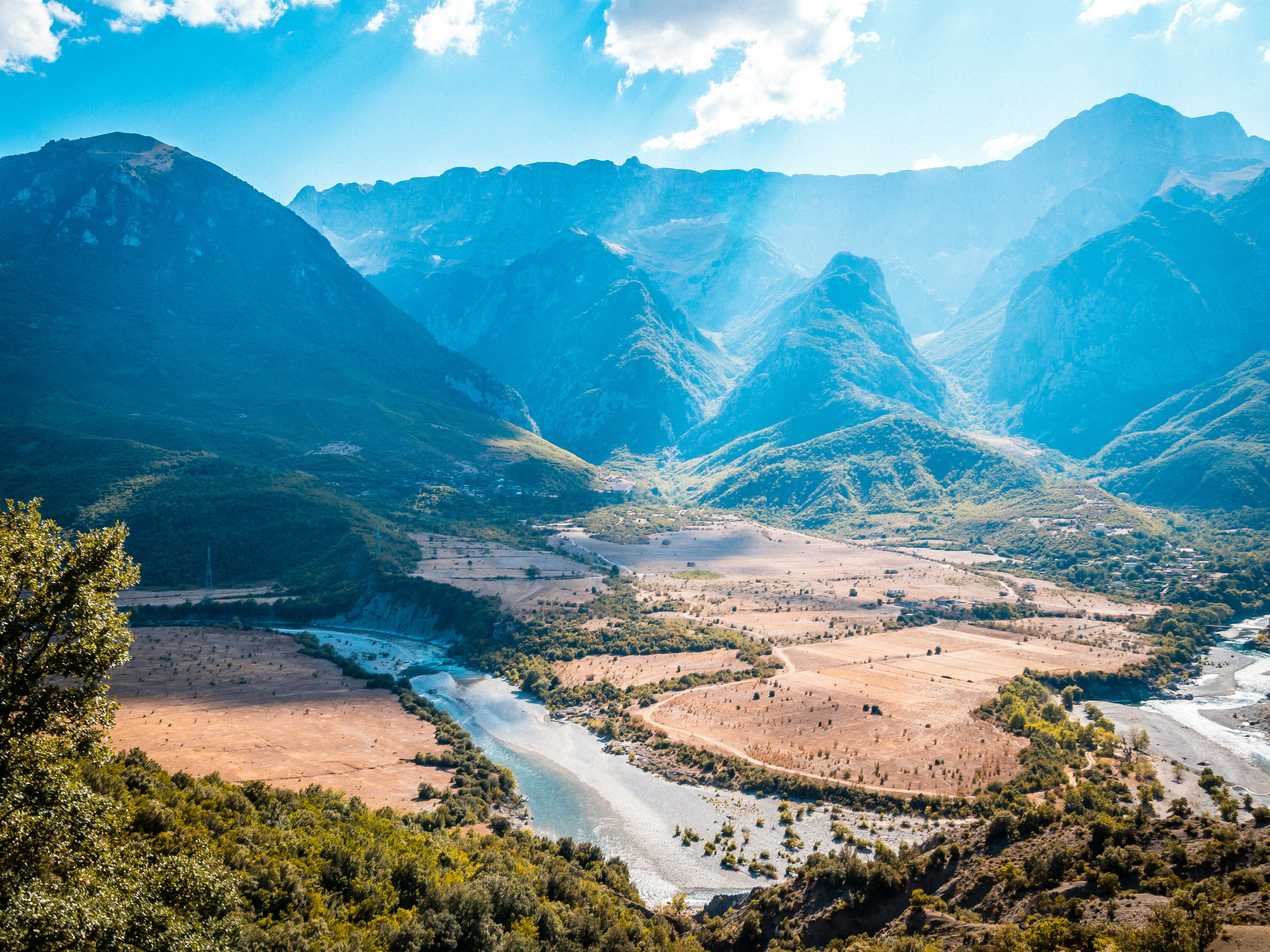 Mountains and a river flow through a valley.