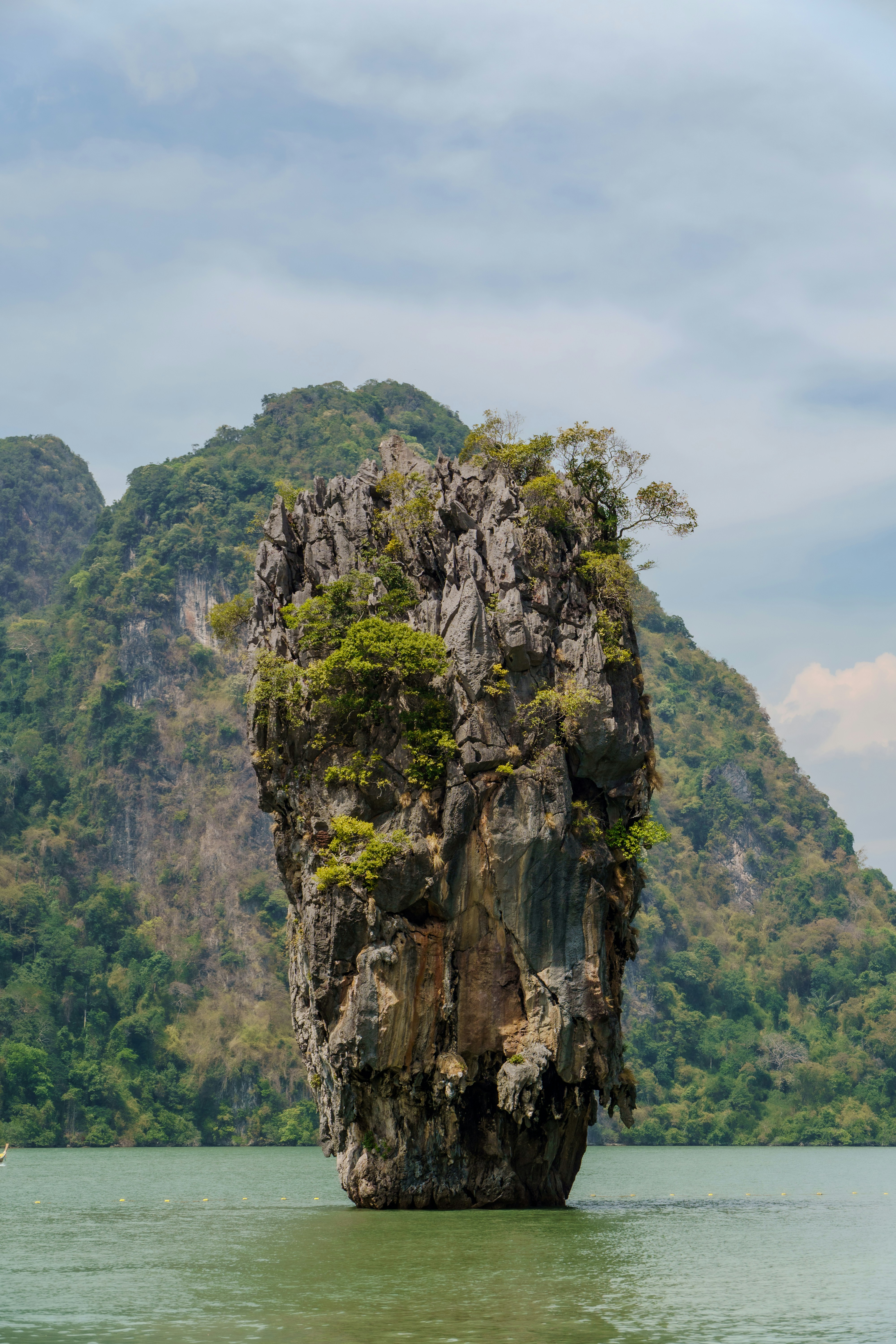 A rocky islet stands in the ocean.
