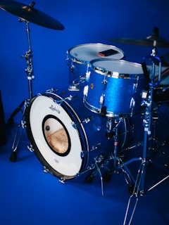 A blue drum kit is ready to be played.