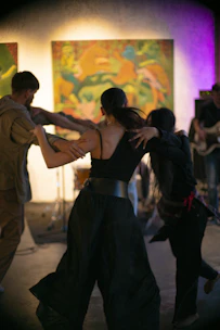 People are dancing at an art exhibit.