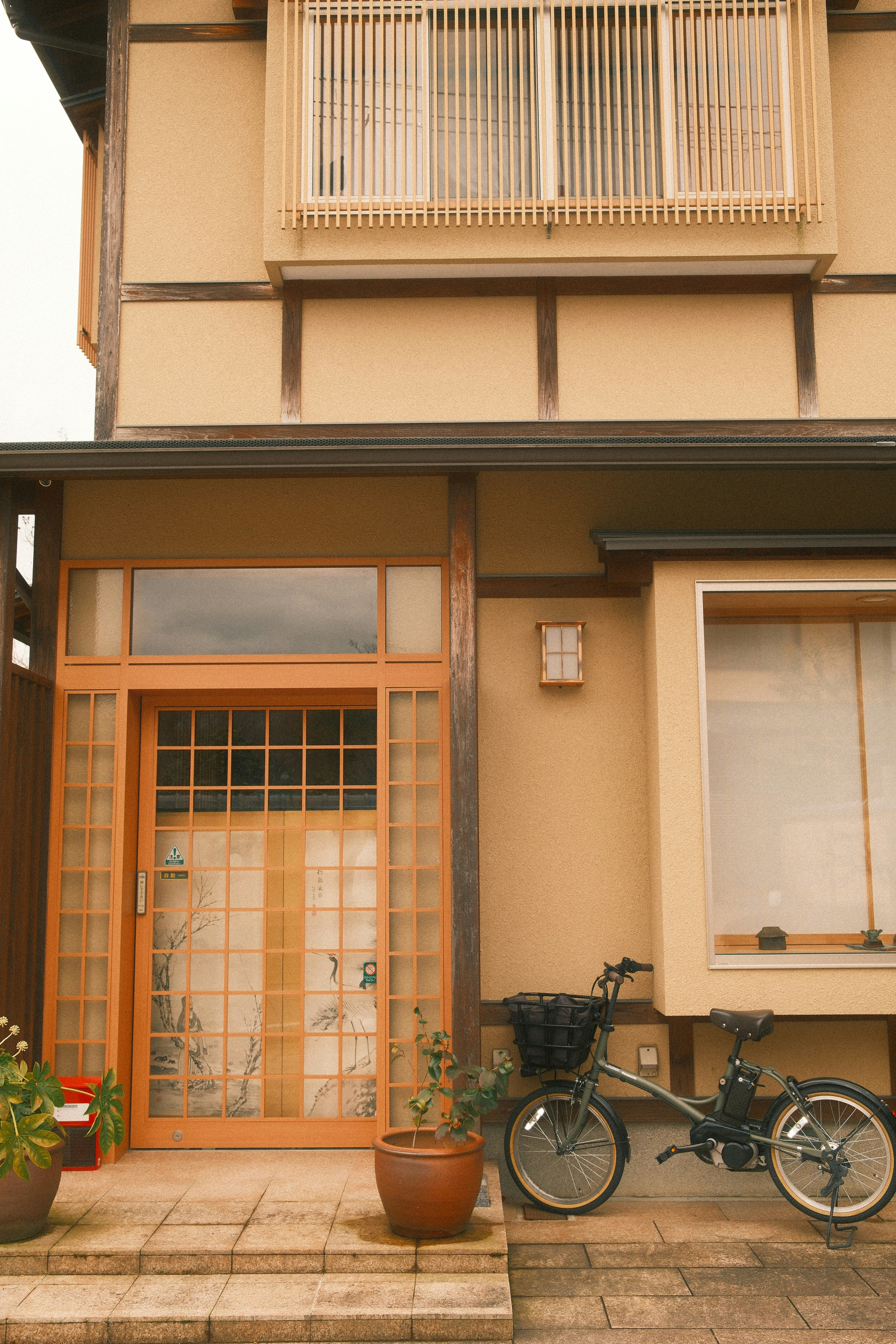 A japanese-style house with a bicycle.
