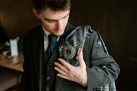 A man admiring his scottish wedding outfit.