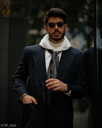 Stylish man in modern city attire posing.
