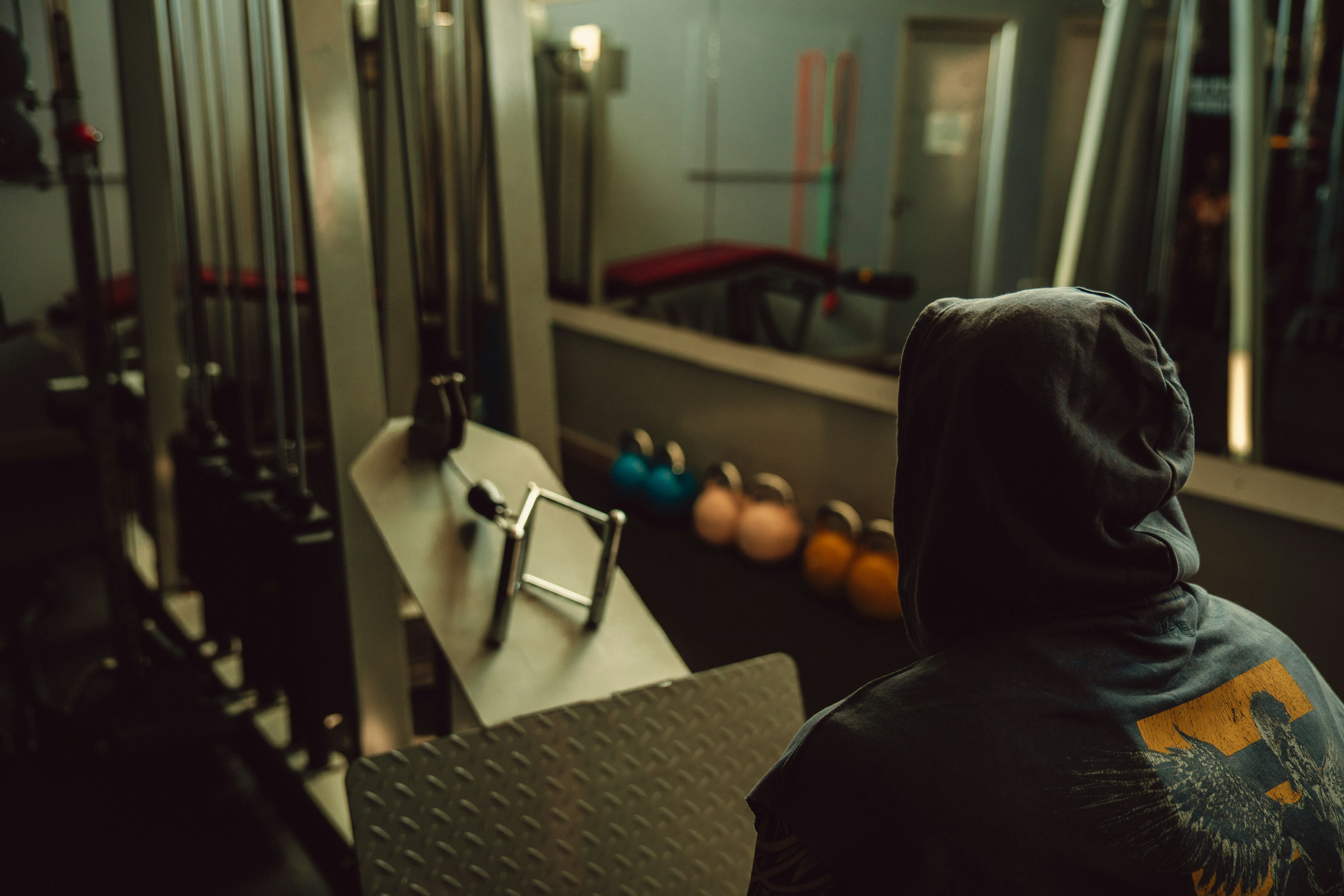 Person inspecting a treadmill during an apartment tour - apartments with fitness center