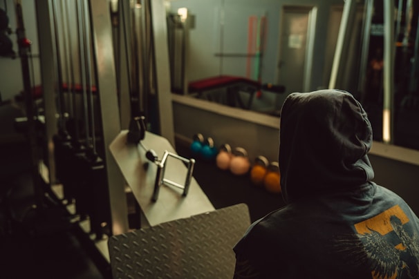 A person in the gym looks in the mirror.
