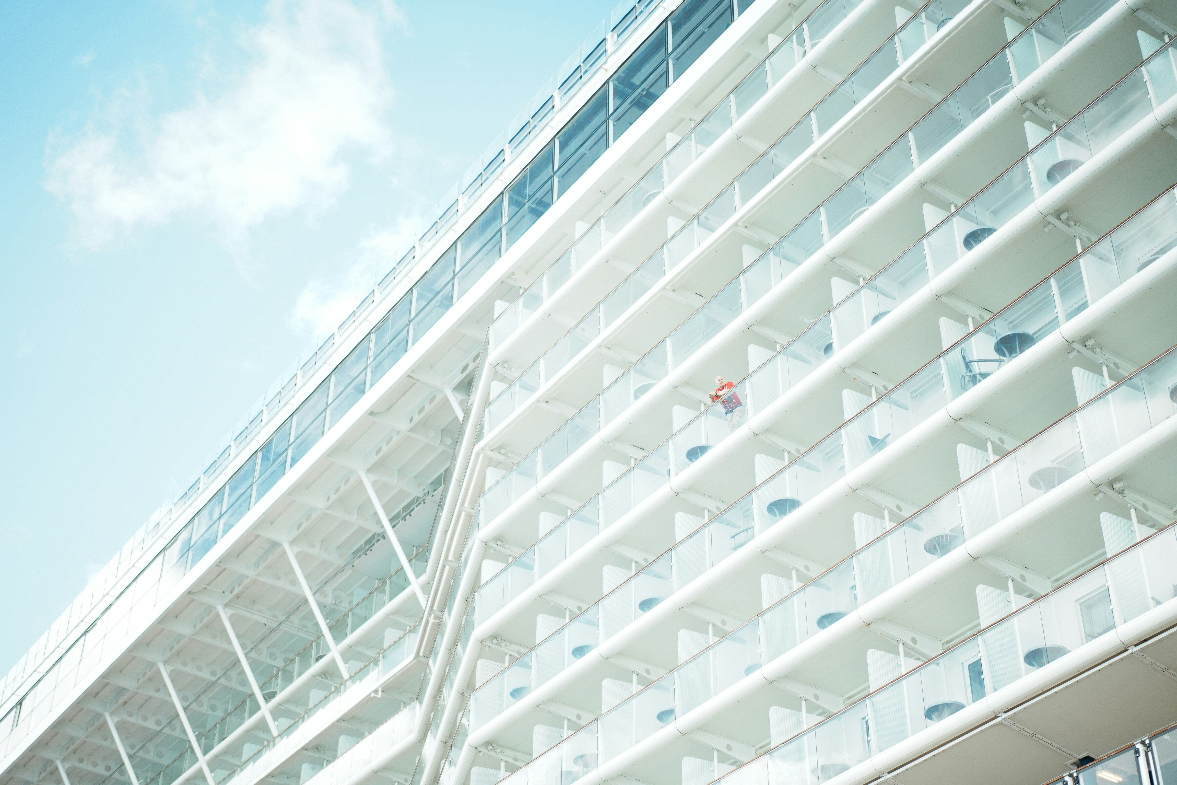 A large cruise ship with many balconies.