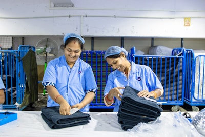 Workers fold jeans in a textile factory.
