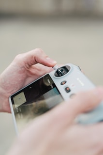 Person holding a drone remote control.