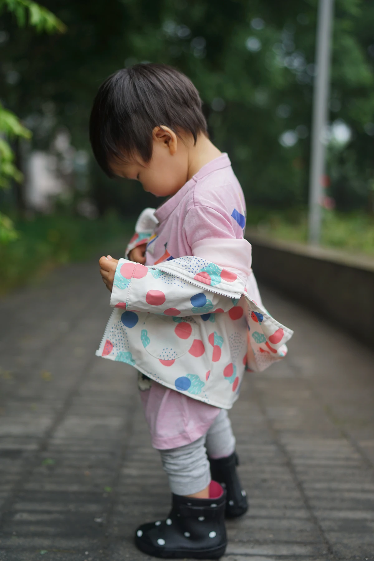 Child in a colourful printed kimono jacket outdoors