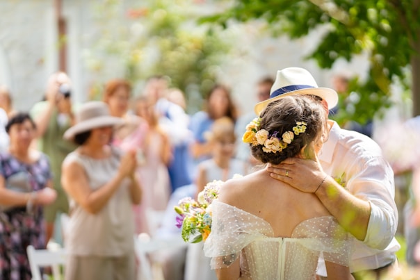 A bride and groom share a kiss at their wedding.
